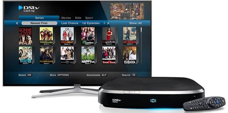 DSTV Explora Decoder and remote in front of a Smart TV